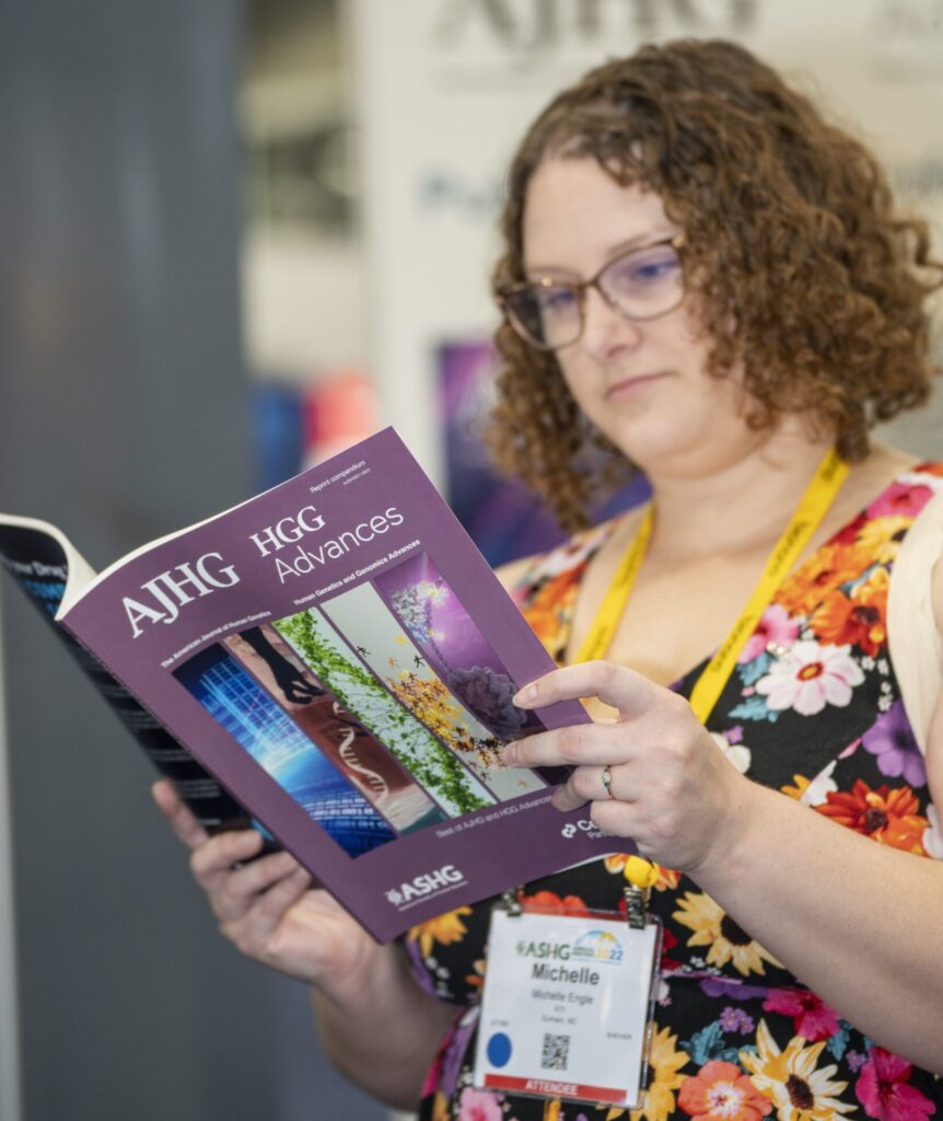 ASHG Meeting Attendee reading a special AJHG/HGGA Journal.