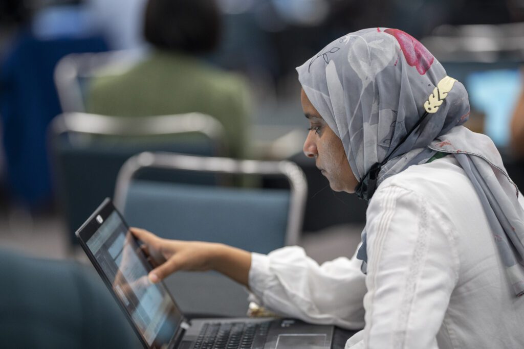 Woman on here Laptop at the meeting.