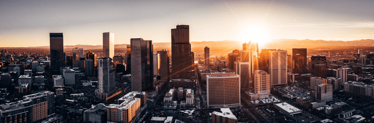 City of Denver Colorado at sunset. Rocky Mountains on the horizon