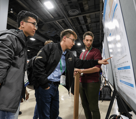 Attendee at the 2023 Meeting discuss abstract posters